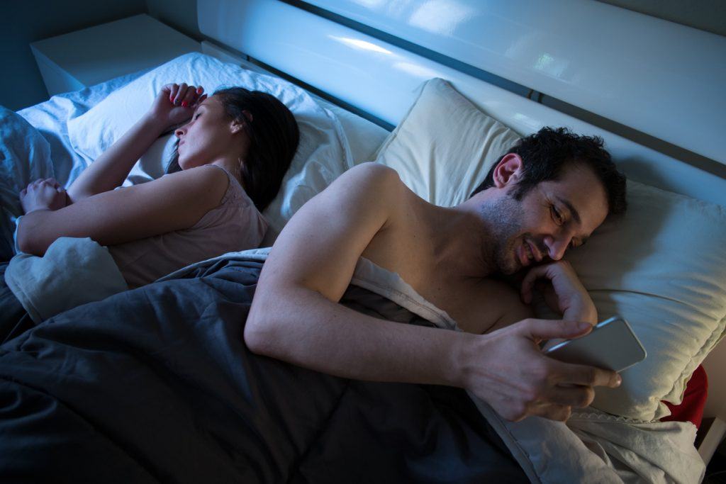 Sly boyfriend using mobile in bed Cheaters never prosper