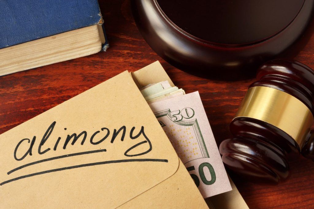 Alimony concept. An envelope with cash on a table. Ask Carolyn: Can I Get More Alimony?